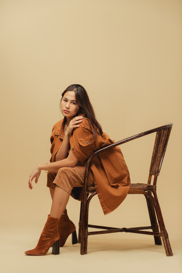 Woman in Brown Monochrome Outfit on Beige Background